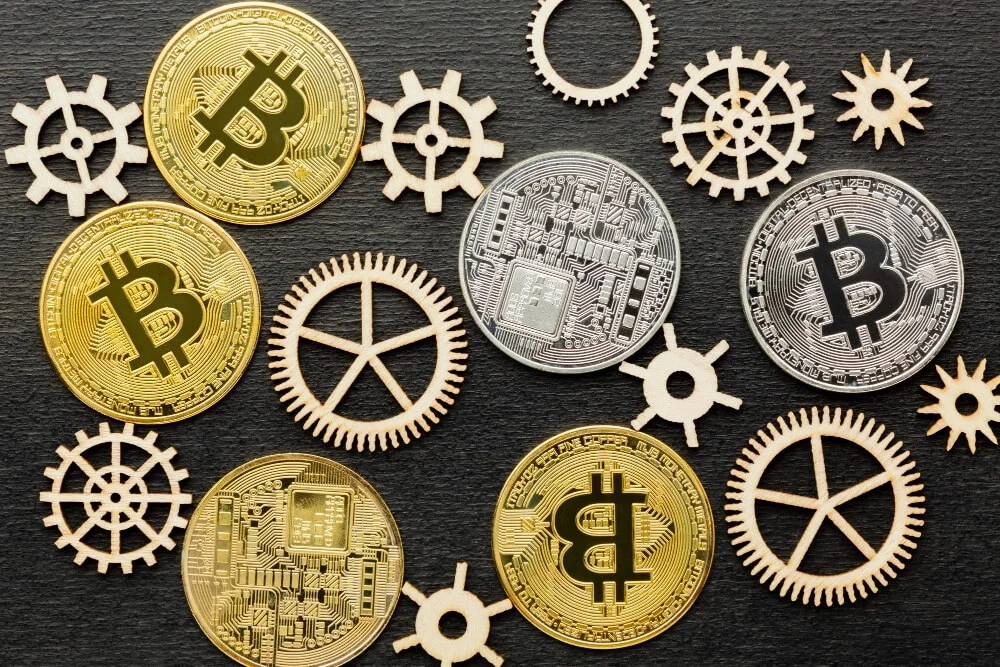A symbolic image showing a gold bar, a US dollar bill, and a Bitcoin coin side by side